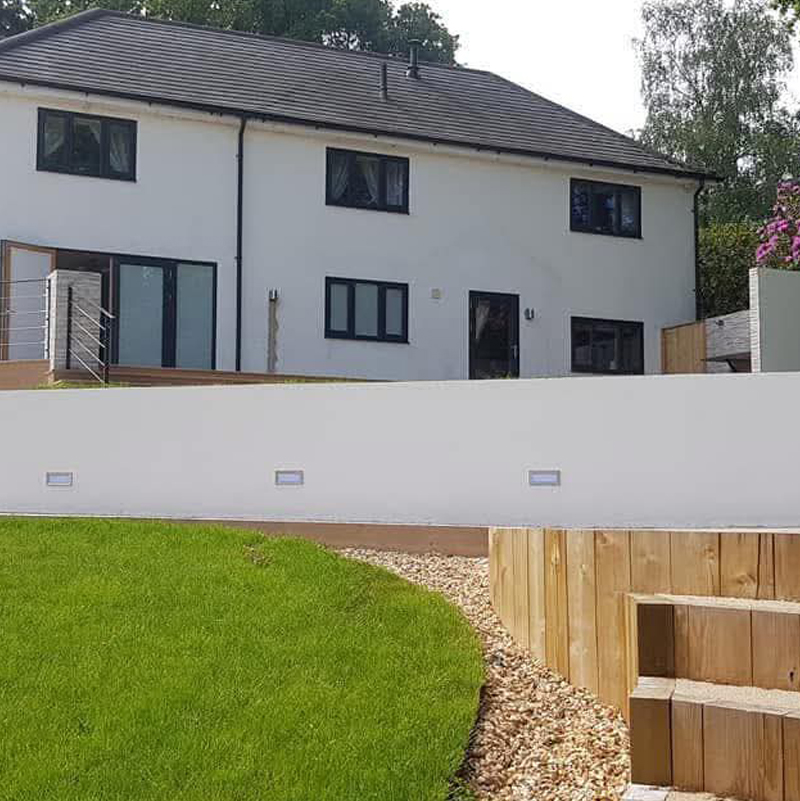 Modern property with high-quality spray rendering on exterior walls and a retaining wall